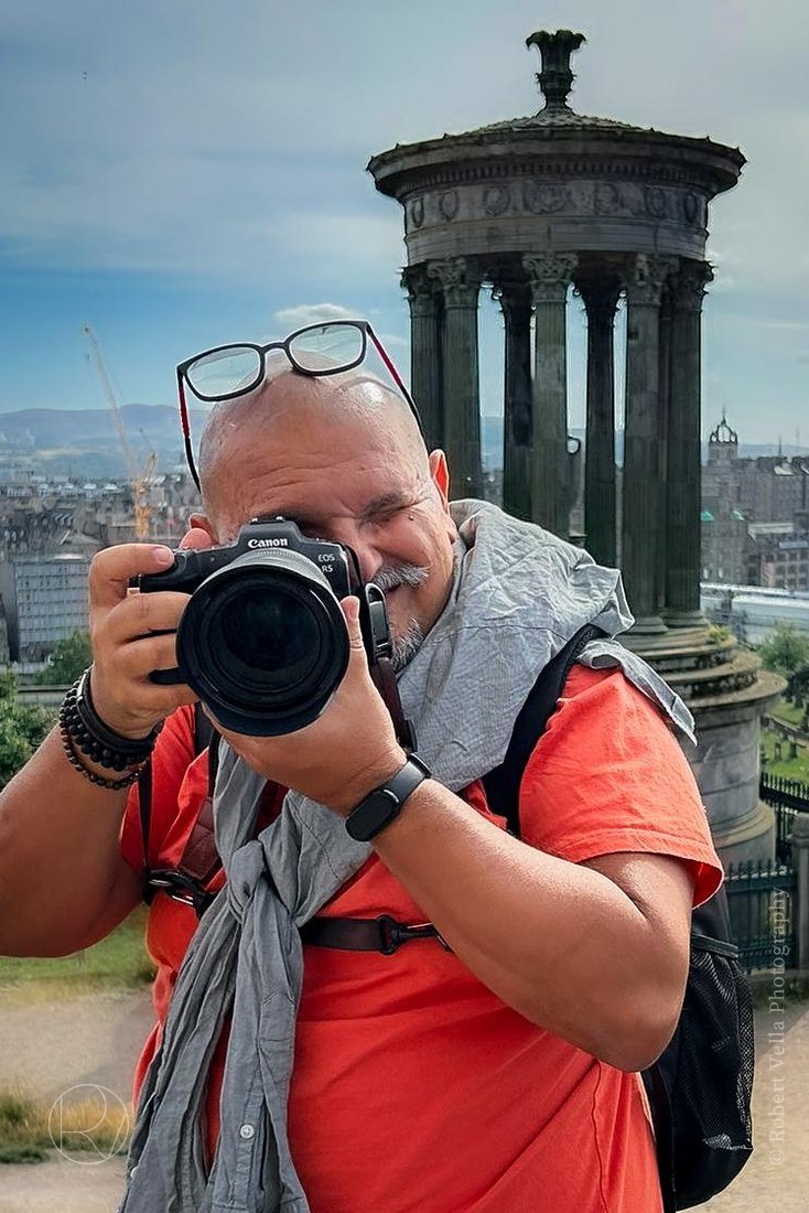 Robert with his Canon to his eye on Calton Hill, Edinburgh, the Dugald Stewart Monument behind him